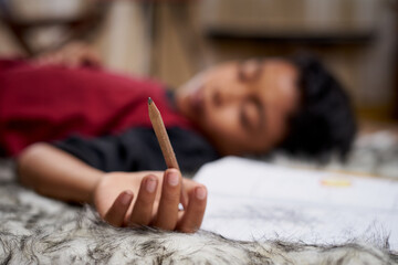 Young student boy fall asleep while study at home