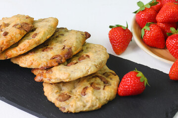 cookie with chocolate on slate plate and strawberry on light background. dessert concept