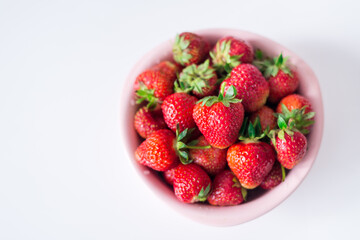 strawberries in a bowl on a white background
