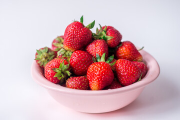 strawberries in a bowl on a white background