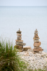 stacked rocks and stones along beach by lake