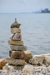 Fototapeta na wymiar stacked rocks and stones along beach by lake
