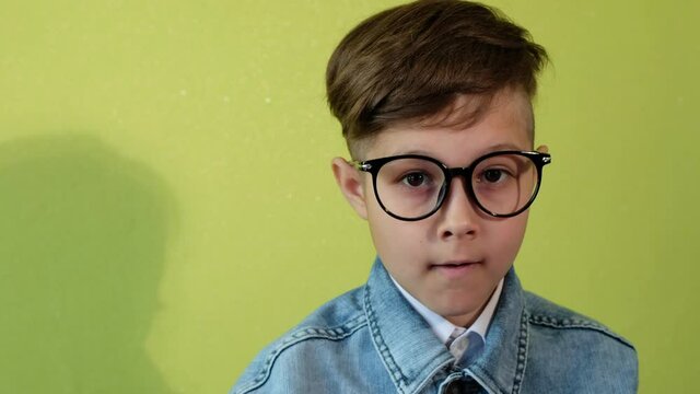 Child with poor eyesight puts on glasses.