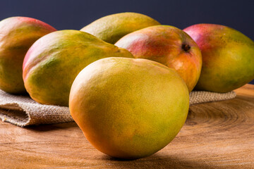 Mango. Some mangos together on wooden background