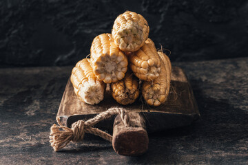 Ripe corn on dark background.