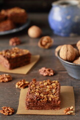 Homemade chocolate and walnuts cake on rustic dark table