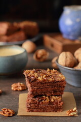 Homemade chocolate and walnuts cake on rustic dark table