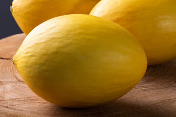 .Whole yellow melon on wooden background