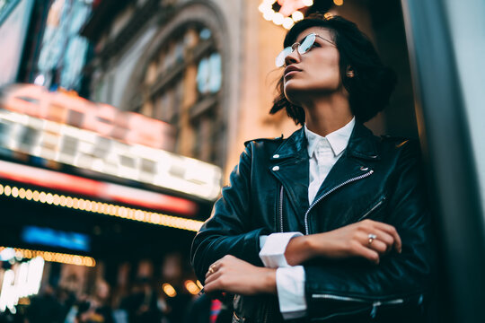 Attractive Young Woman In Stylish Outfit Looking At Modern Architecture In New York City Standing On Publicity Area, Thoughtful Hipster Girl Spending Time Outdoors On Urban Settings Of Manhattan.