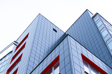 Corners of buildings with many windows against a white sky. The concept of a modern office building