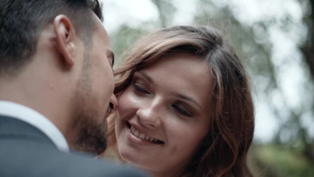 Portrait of young couple in love full of passion and emotions, man on dating kissing his pretty girlfriend and smiling, love and tenderness in air. Romantic dating of man and woman, affection from the