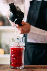 The bartender prepares a berry cocktail on the terrace of the restaurant.