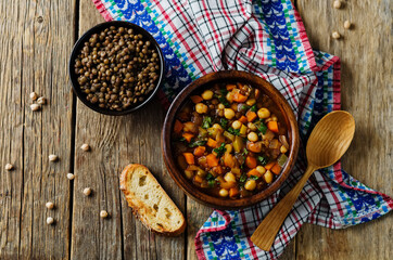 Moroccan spicy green lentils chickpea soup in a dark bowl