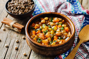Moroccan spicy green lentils chickpea soup in a dark bowl