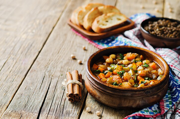 Moroccan spicy green lentils chickpea soup in a dark bowl