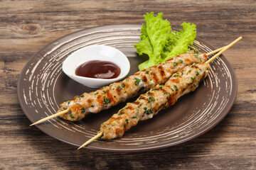 Minced pork skewer kebab with sauce