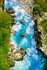 It's Transparent river with the reflection of the sky and clouds on the water