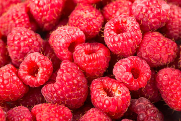 Fresh and sweet raspberries. Texture of raspberries close up. Vegetarian concept.