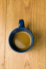 Blue mug with coffee on a wooden table
