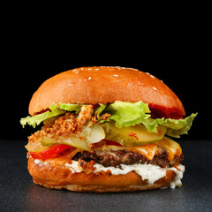 tasty burger with chicken on dark isolated background. Homemade hamburger or burger with fresh vegetables and cheese