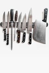 Kitchen knives set on a magnet. Copy space.