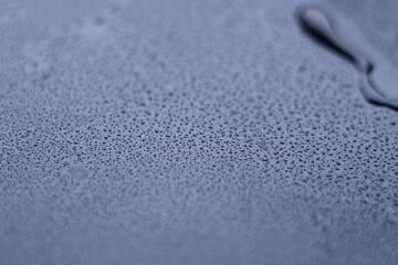 drops of pod on frosted glass on a dark background