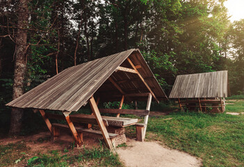Wooden gazebo in forest for outdoor recreation. Wonderful nature place for leisure travelers