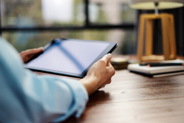 Woman pointing on digital tablet screen, chatting in social networks, meeting website, searching internet, sending sms, using text messenger or online banking. Close up photo