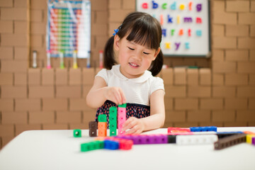 toddler girl play number blocks for homeschooling