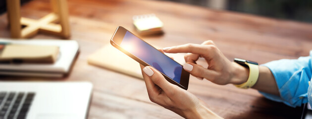 Woman pointing on smartphone screen, chatting in social networks, meeting website, searching...
