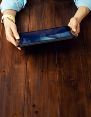 Close up photo of female hands with a digital tablet