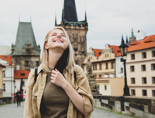 girl removes mask from face on the street of Prague after the pandemic