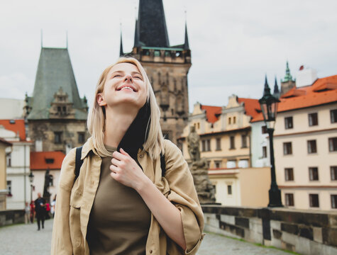 girl removes mask from face on the street of Prague after the pandemic