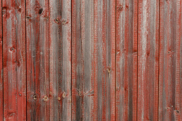 Fototapeta premium Old gray with shabby red paint wooden wall, aged background and texture. Rustic wooden board of fence. natural patterns background