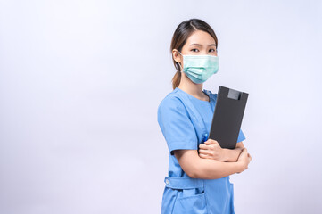 Portrait of young Asian nurse wearing surgical mask holding clipboard. concept of occupation and career