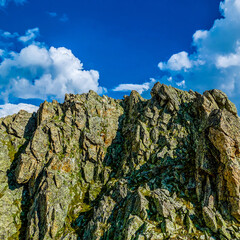 Picturesque mountain scenery with cumulus clouds. Wildlife. Hiking. Daytime. trip