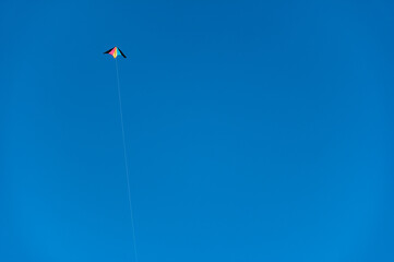 Fototapeta na wymiar Kite in Upper Corner Blue Sky