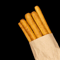 Crispy breadsticks, grissini on dark background