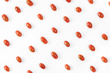 Grape tomato pattern on white background. Small tomatoes cherry top view. Organic baby plum tomatoes flat lay. Creative layout. Red vegetables, healthy eating concept
