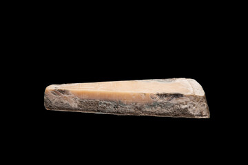 Concept - Expired Products. Spoiled cheese isolated on a black background. Mold indicates the naturalness of the product
