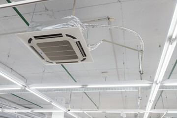 Rectangular ceiling air conditioning appliance. Fan Coil hanging on ceiling. industrial climate gear