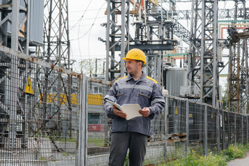 The energy engineer inspects the equipment of the substation. Power engineering. Industry