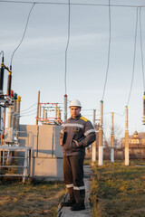 The energy engineer inspects the equipment of the substation. Power engineering. Industry