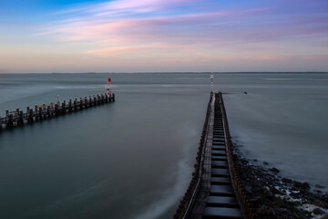Fototapeta premium Vlissingen - tidal breakwaters leading from the shore to the sea at the end are lighthouses. It calmed the sea level for a long time.