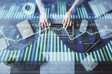 Double exposure of woman hands working on computer and data theme hologram drawing. Top View. Technology concept.