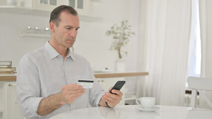 Middle Aged Man making Successful Payment on Smartphone