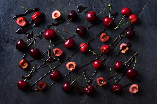 Cherries and chocolate on stone surface food design collage