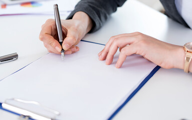 close up of a businesswoman signing a contract