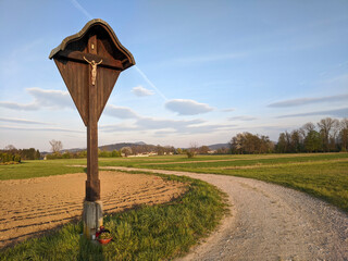 Roadside statue of Jesus next to a field