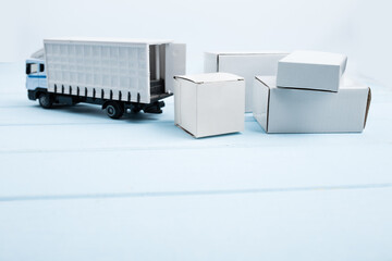 Toy delivery truck with boxes and wooden cubes on blue background